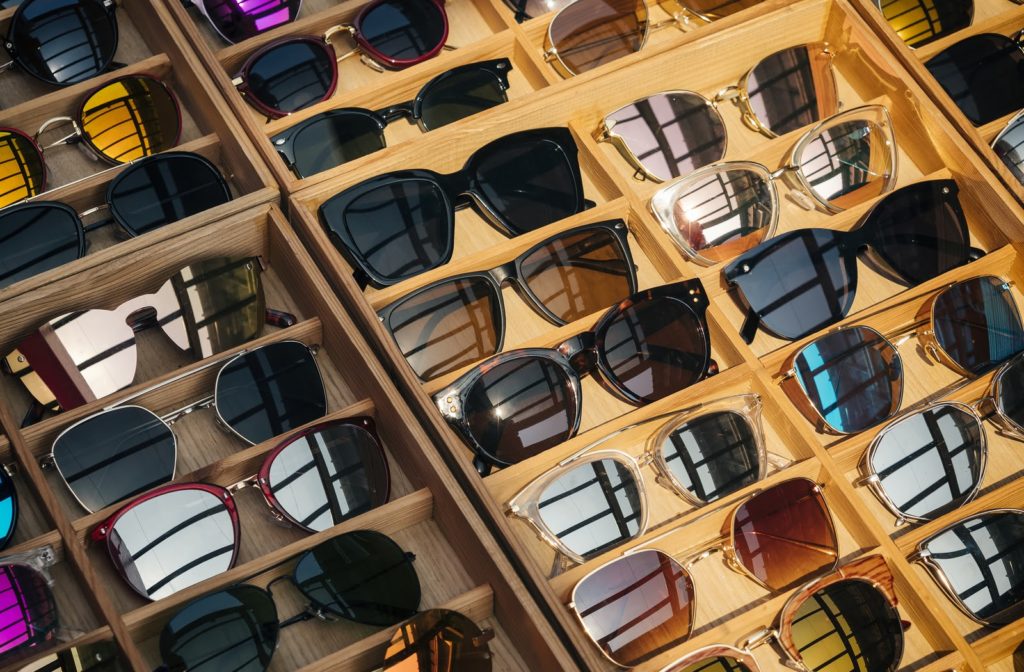 Sunglasses on display in wooden trays