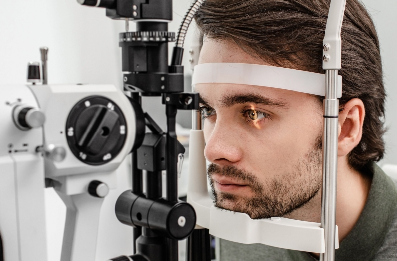 Close-up of a man undergoing a slit-lamp exam.