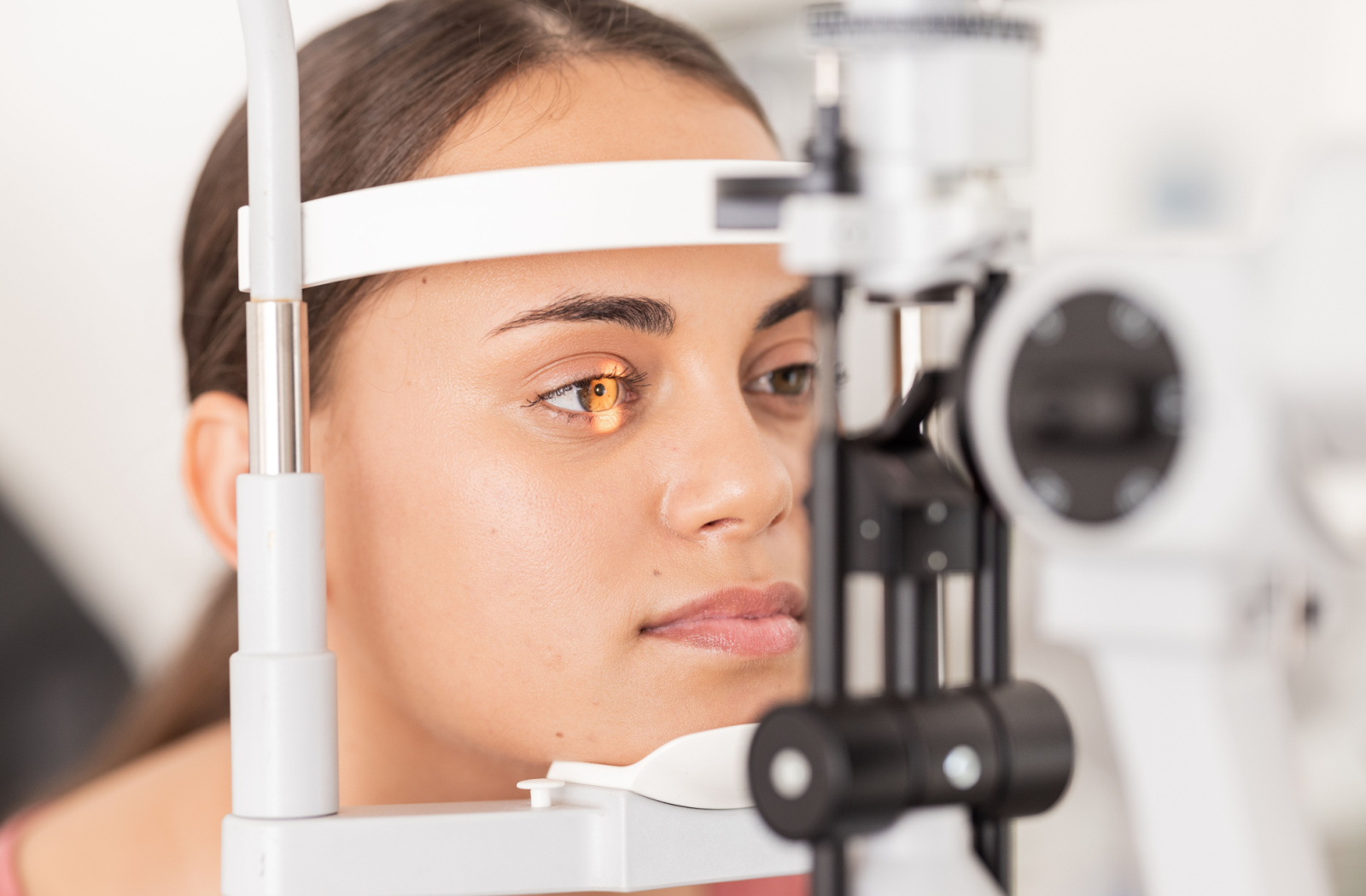 Close-up of a woman undergoing a slit-lamp exam.